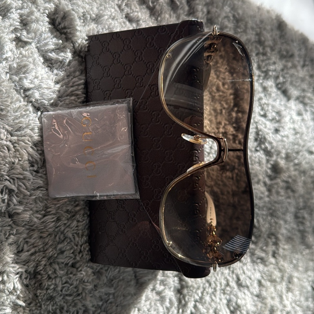 Gucci brand sunglasses. Color white with light tan lenses.